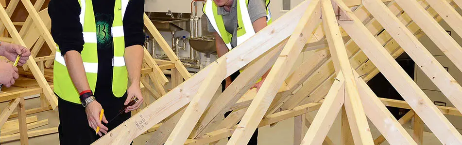 carpentry class with students working on timber